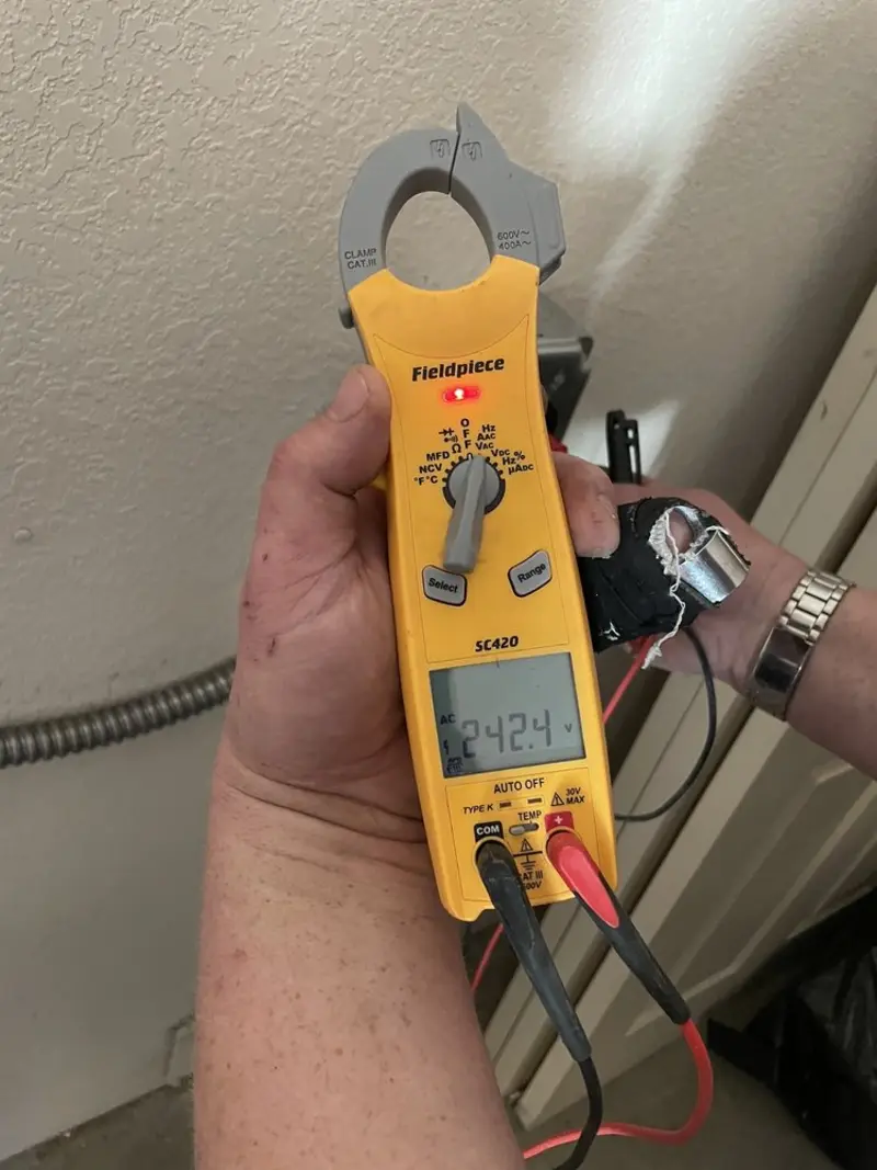 Voltage testing with clamp meter during Outlet Installation in Prairie Heights